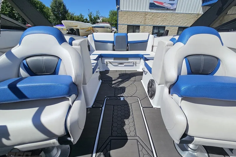 Slide: The Image of 2022 Scarab 255 Wake ID boat interior with blue and white seating, outdoor setting. - 103