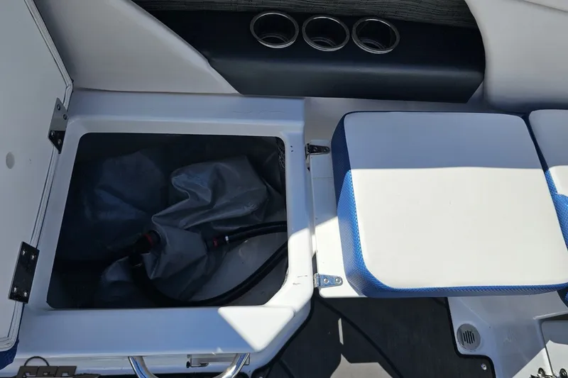 Slide: The Image of 2022 Scarab 255 Wake ID boat interior storage compartment with seating and cup holders. - 47