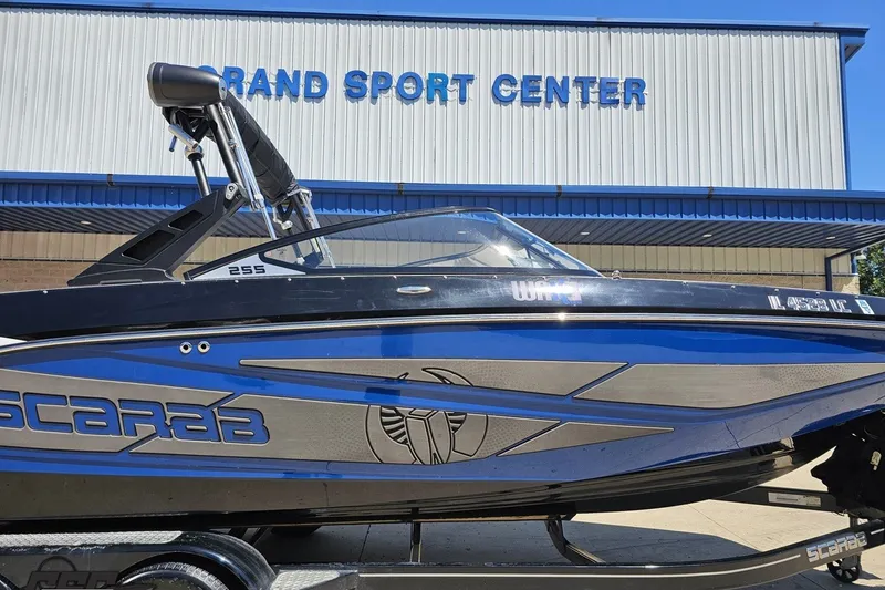 Slide: The Image of 2022 Scarab 255 Wake ID boat displayed at a sports center. - 4