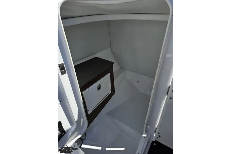 Slide: The Image of Interior cabin of 2022 Scarab 255 Wake ID boat, featuring compact storage space. - 67