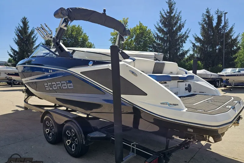 Slide: The Image of 2022 Scarab 255 Wake ID boat on trailer, featuring sleek design and modern amenities. - 29