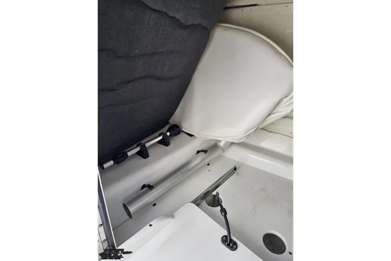 Slide: The Image of Interior view of 2022 Scarab 255 Wake ID boat, featuring seating and storage area. - 82