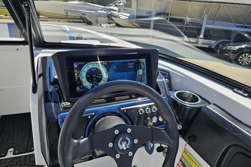 Slide: The Image of 2022 Scarab 255 Wake ID boat dashboard with steering wheel and digital display. - 73