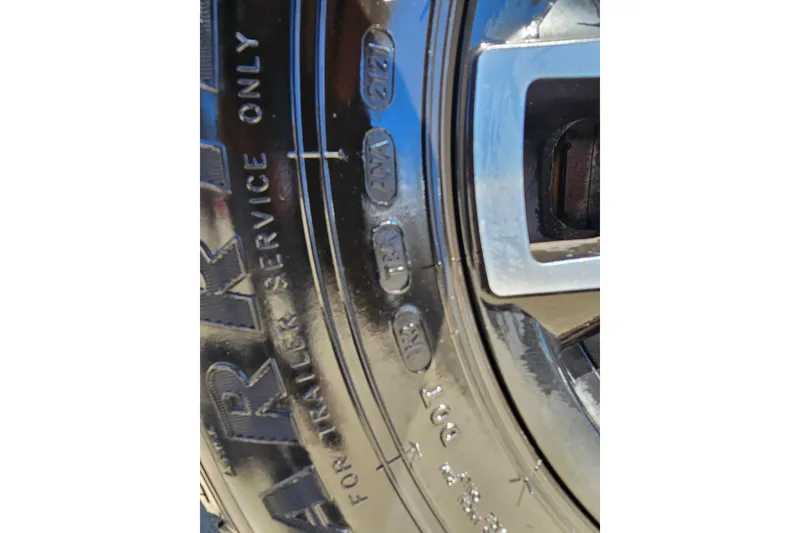 Slide: The Image of Close-up of a Scarab 255 Wake ID 2022 trailer tire with embossed text. - 120