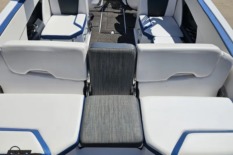 Slide: The Image of Interior seating of 2022 Scarab 255 Wake ID boat, featuring white and blue upholstery. - 38