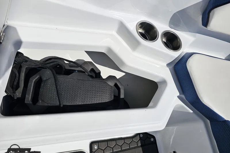 Slide: The Image of Interior storage compartment of 2022 Scarab 255 Wake ID boat with cup holders. - 95