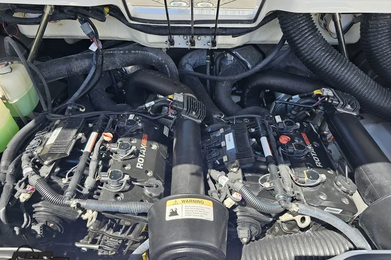Slide: The Image of Engine compartment of a 2022 Scarab 255 Wake ID boat, featuring dual Rotax engines. - 116
