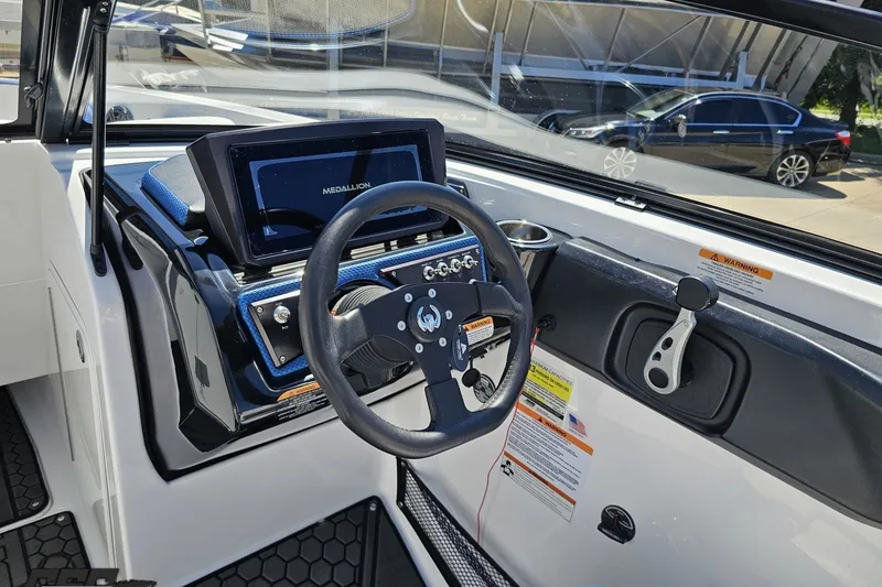Slide: The Image of 2022 Scarab 255 Wake ID boat dashboard with steering wheel and digital display. - 71