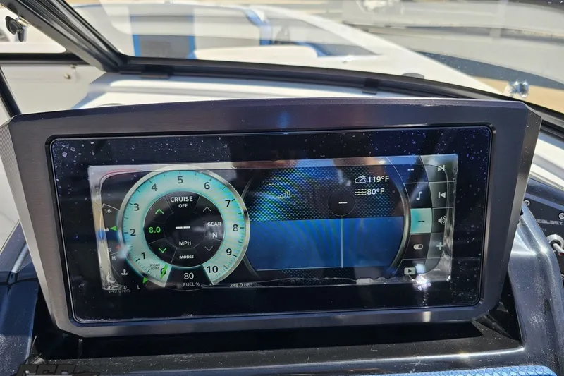 Slide: The Image of Dashboard of a 2022 Scarab 255 Wake ID boat displaying speed and temperature. - 74
