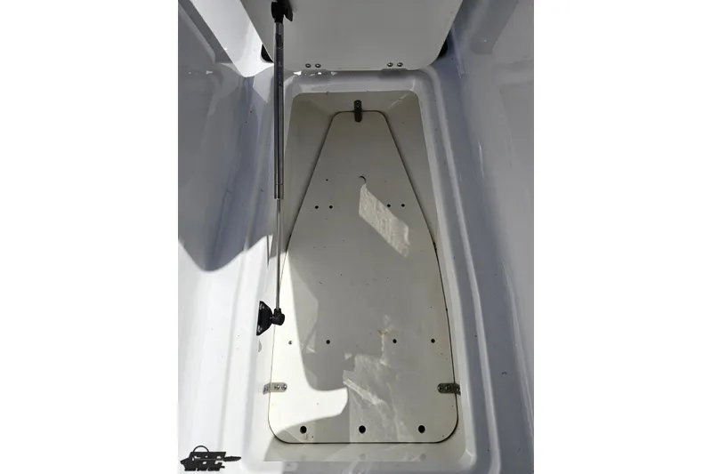 Slide: The Image of 2022 Scarab 255 Wake ID boat storage compartment, open and empty. - 101