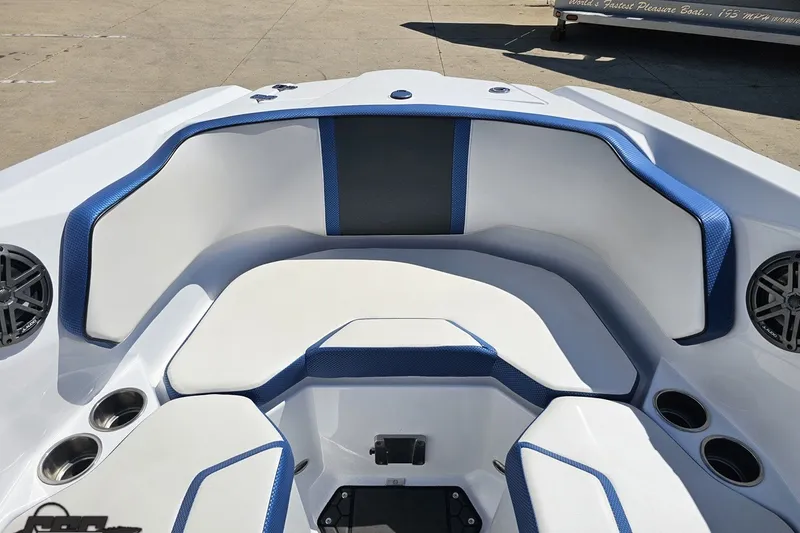 Slide: The Image of 2022 Scarab 255 Wake ID boat interior with blue and white seating and cup holders. - 92
