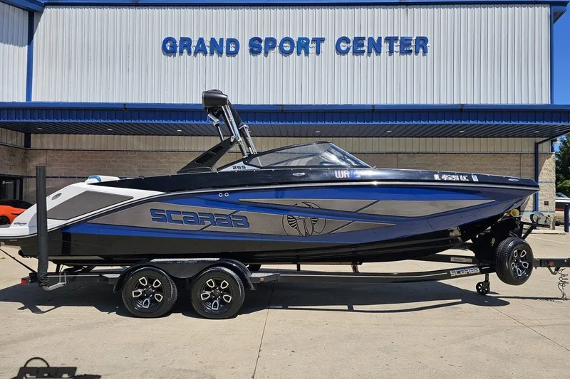 Slide: The Image of 2022 Scarab 255 Wake ID boat on trailer at Grand Sport Center. - 3