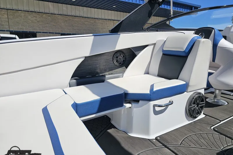 Slide: The Image of 2022 Scarab 255 Wake ID boat interior with blue and white seating, speaker, and modern design. - 50