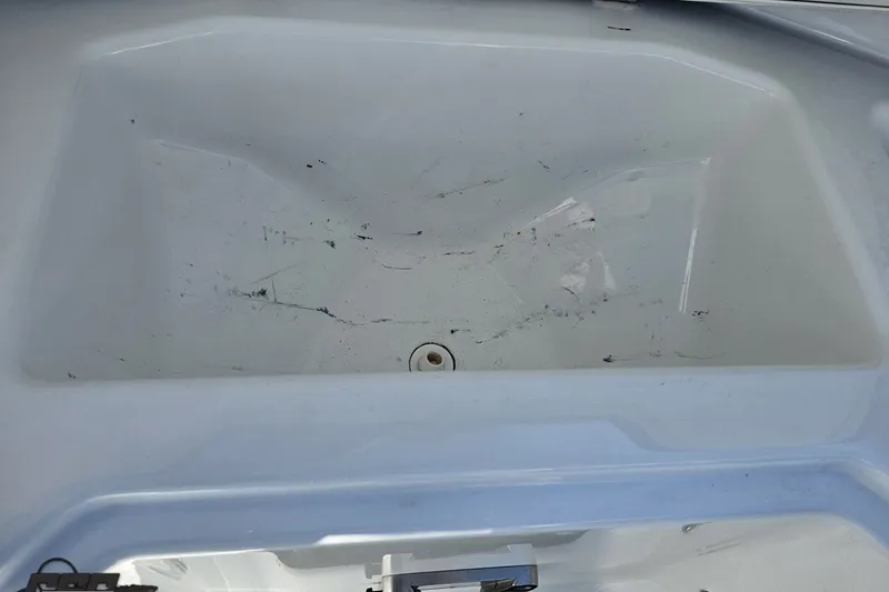 Slide: The Image of Interior view of a 2022 Scarab 255 Wake ID boat, showing a clean, empty compartment. - 97