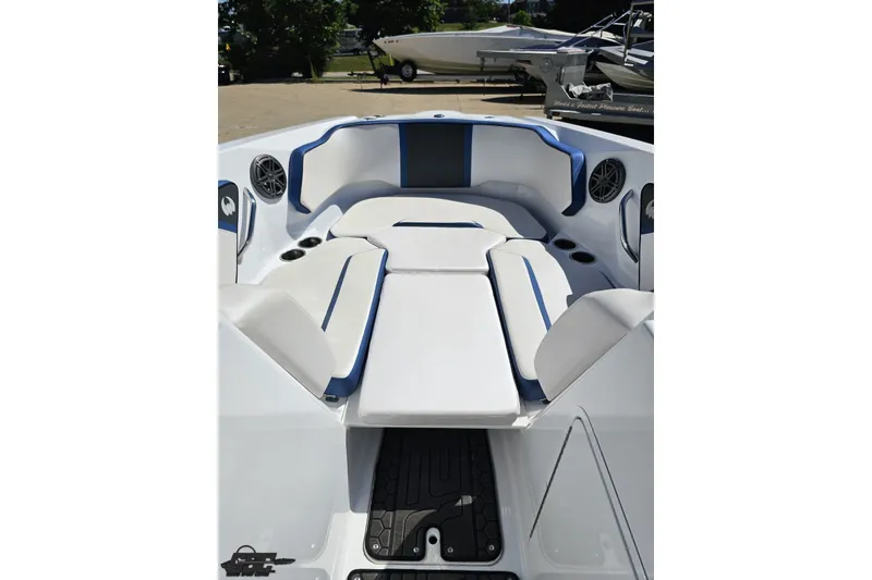 Slide: The Image of 2022 Scarab 255 Wake ID boat interior with white and blue seating, cup holders, and speakers. - 87