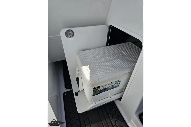 Slide: The Image of 2022 Scarab 255 Wake ID boat with Igloo cooler in storage compartment. - 81