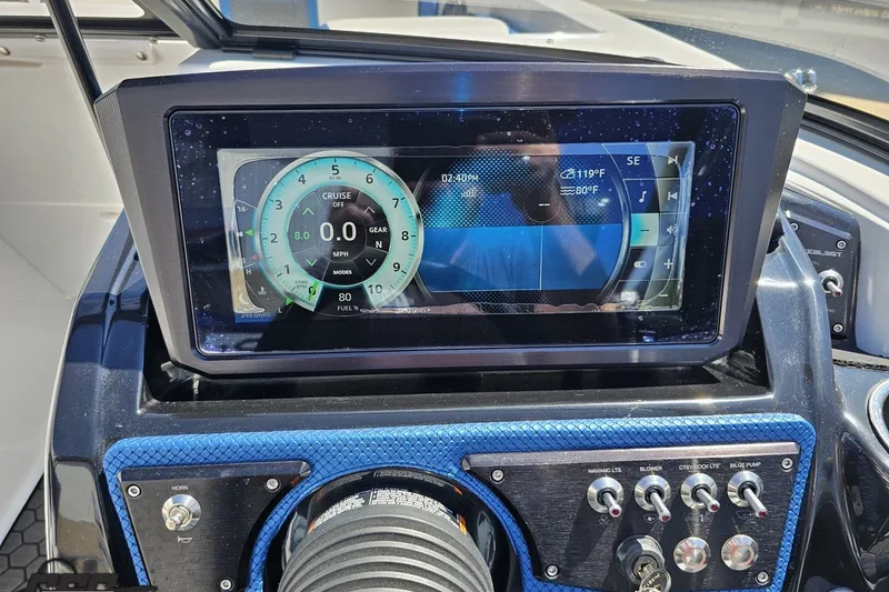 Slide: The Image of Dashboard of a 2022 Scarab 255 Wake ID boat with digital display and controls. - 77