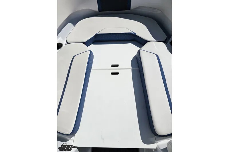 Slide: The Image of 2022 Scarab 255 Wake ID boat interior with white and blue cushioned seating. - 89