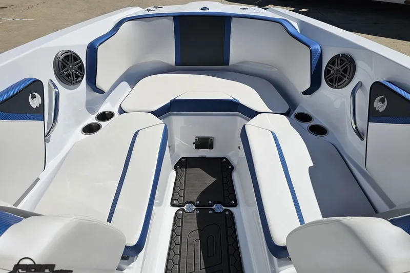 Slide: The Image of 2022 Scarab 255 Wake ID boat interior with white and blue seating, cup holders, and speakers. - 91