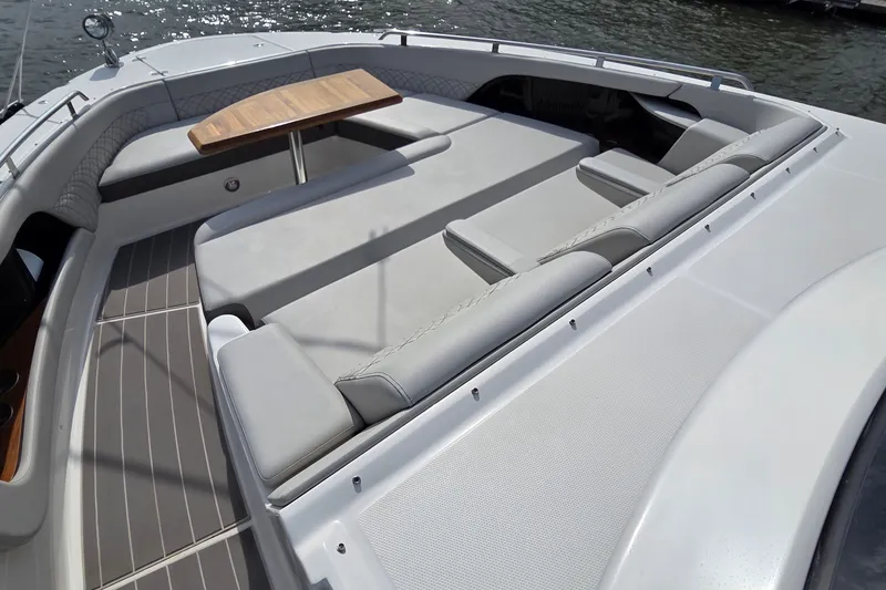 Slide: The Image of 2023 Sea Ray Sundancer 370 Outboard with spacious seating and wooden table on deck. - 14