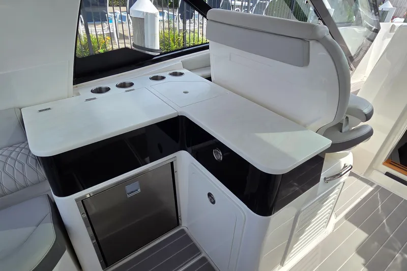 Slide: The Image of 2023 Sea Ray Sundancer 370 Outboard interior with sleek kitchenette and seating area. - 13