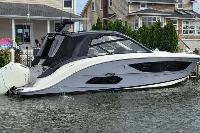 Slide: The Image of 2023 Sea Ray Sundancer 370 Outboard docked near waterfront homes. - 1