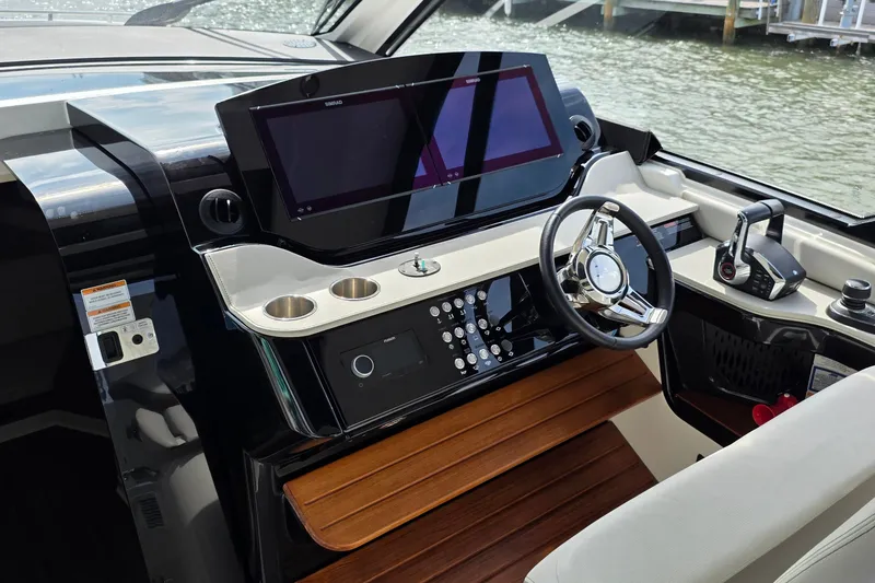 Slide: The Image of 2023 Sea Ray Sundancer 370 Outboard helm with modern controls and sleek design. - 4