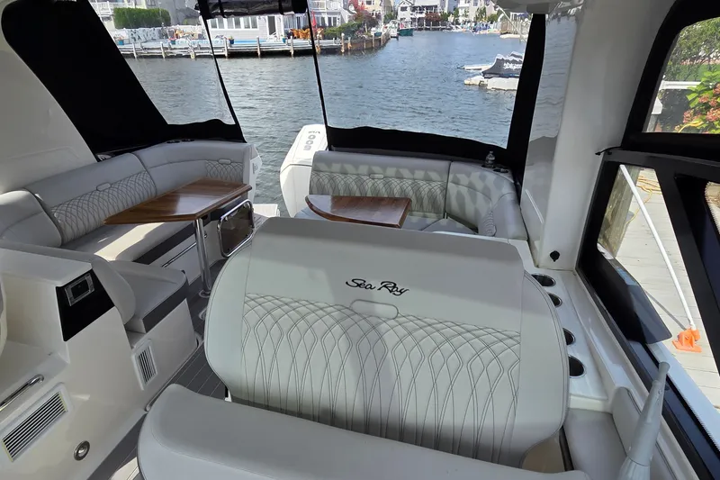 Slide: The Image of Luxurious interior of 2023 Sea Ray Sundancer 370 Outboard, featuring elegant seating and waterfront view. - 18