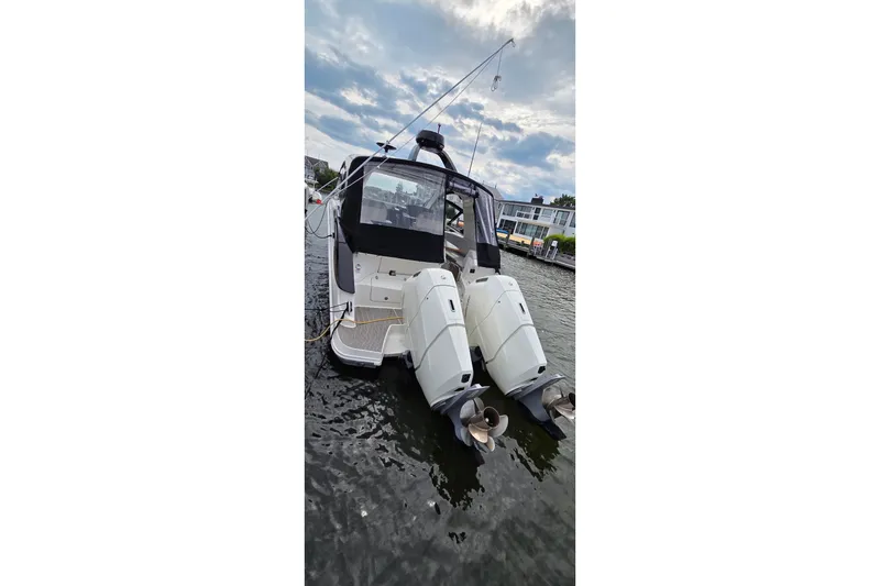 Slide: The Image of 2023 Sea Ray Sundancer 370 Outboard docked, showcasing dual engines and sleek design. - 30