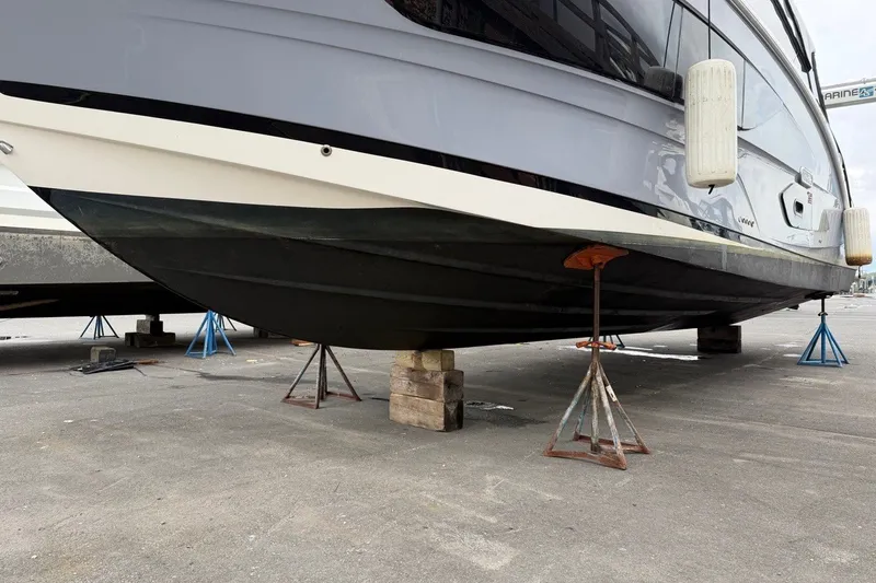 Slide: The Image of 2023 Sea Ray Sundancer 370 Outboard on stands for maintenance. - 31