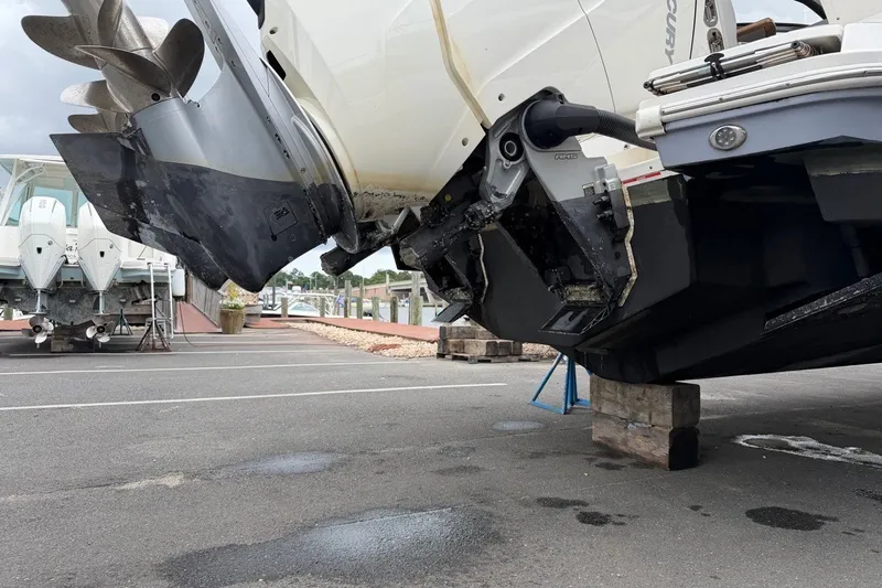 Slide: The Image of 2023 Sea Ray Sundancer 370 Outboard on blocks, showcasing propellers and outboard motor. - 32