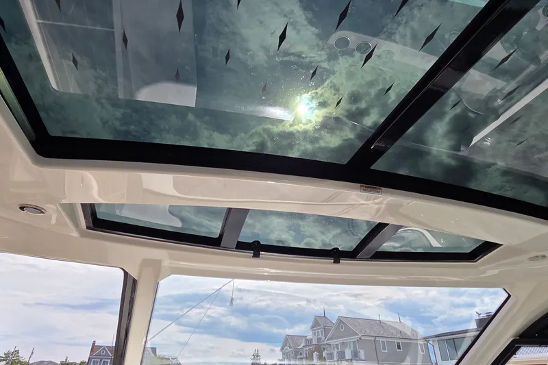 Slide: The Image of Sunroof view from 2023 Sea Ray Sundancer 370 Outboard, showcasing sky and architecture. - 29