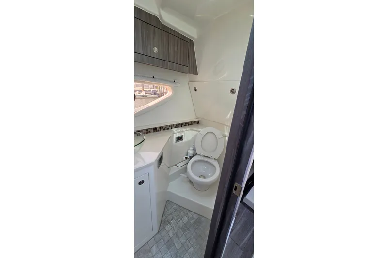 Slide: The Image of 2023 Sea Ray Sundancer 370 Outboard bathroom with modern fixtures and sleek design. - 23