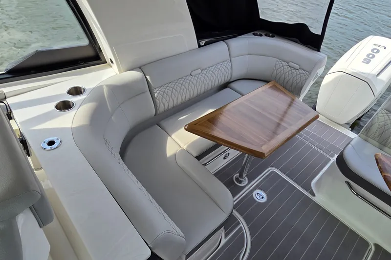 Slide: The Image of Luxurious seating area on 2023 Sea Ray Sundancer 370 Outboard with elegant wooden table. - 11