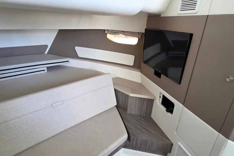 Slide: The Image of 2023 Sea Ray Sundancer 370 Outboard cabin interior with TV and seating area. - 21