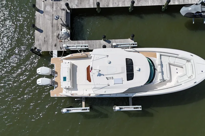Slide: The Image of Aerial view of 2025 Tiara Yachts 43 LS docked, showcasing sleek design and twin engines. - 6