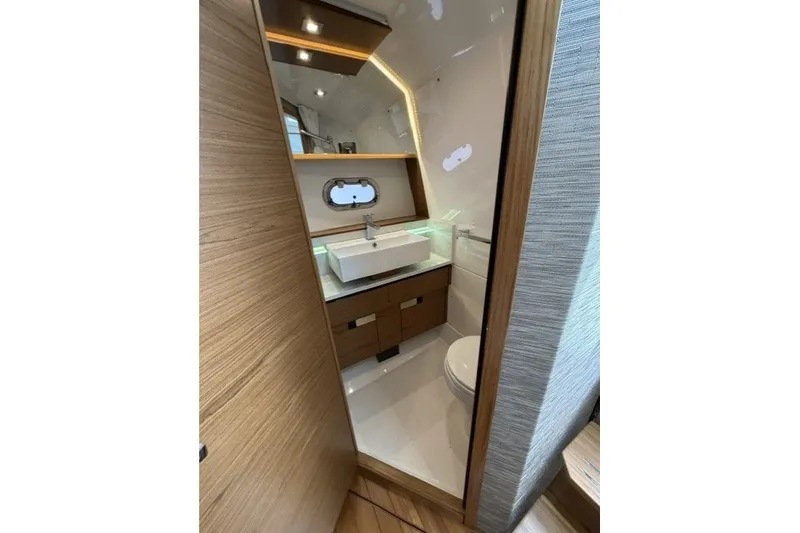 Slide: The Image of Luxurious bathroom interior of 2025 Tiara Yachts 43 LS, featuring modern sink and wooden cabinetry. - 29