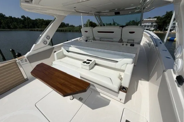 Slide: The Image of 2025 Tiara Yachts 43 LS luxury boat interior with elegant seating and wooden table. - 22