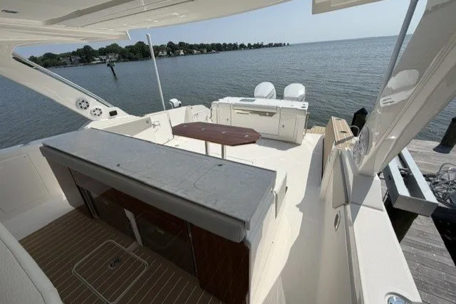 Slide: The Image of 2025 Tiara Yachts 43 LS luxury boat interior with seating and ocean view. - 17