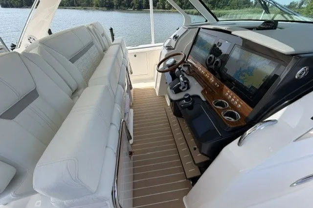 Slide: The Image of 2025 Tiara Yachts 43 LS helm with luxurious seating and advanced navigation system. - 14