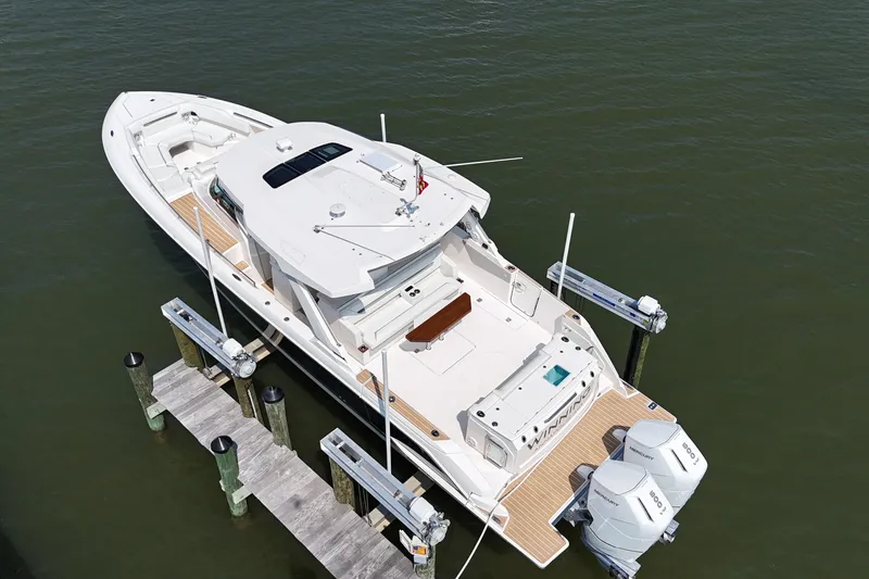 Slide: The Image of 2025 Tiara Yachts 43 LS docked, showcasing sleek design and powerful outboard engines. - 5
