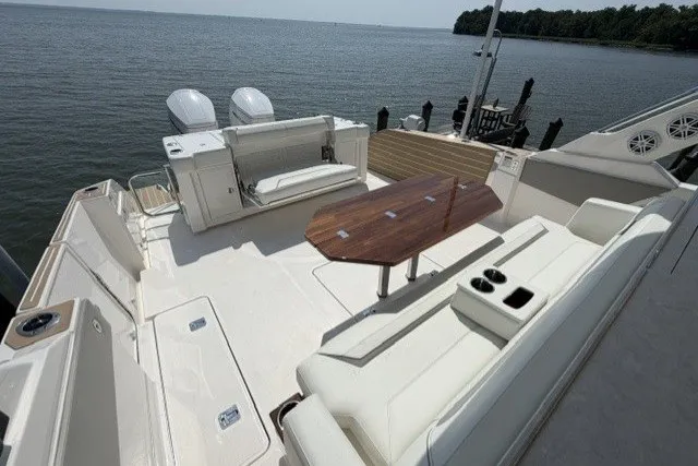 Slide: The Image of 2025 Tiara Yachts 43 LS with spacious deck, seating, and table overlooking serene waters. - 21