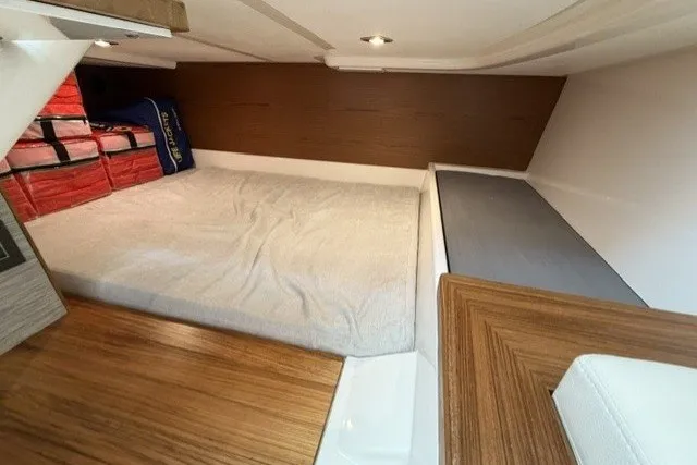 Slide: The Image of Interior cabin of 2025 Tiara Yachts 43 LS, featuring a cozy bed and modern design. - 25