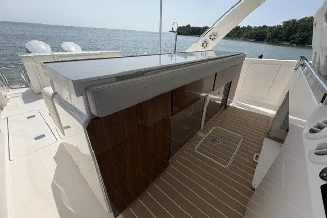 Slide: The Image of 2025 Tiara Yachts 43 LS luxury yacht deck with sleek cabinetry and scenic water view. - 20
