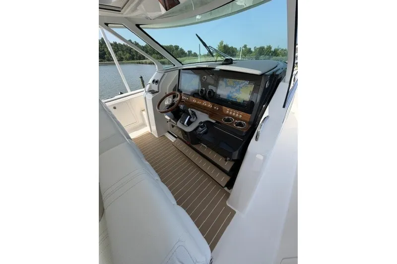 Slide: The Image of 2025 Tiara Yachts 43 LS helm with advanced navigation displays and luxurious interior. - 15