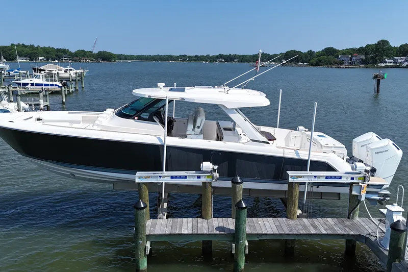 Slide: The Image of 2025 Tiara Yachts 43 LS docked, showcasing sleek design and modern features on a serene waterfront. - 3
