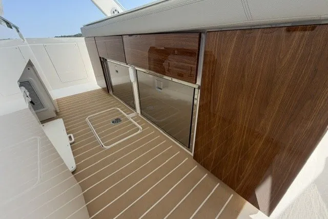 Slide: The Image of 2025 Tiara Yachts 43 LS interior with sleek wood cabinetry and modern flooring. - 19