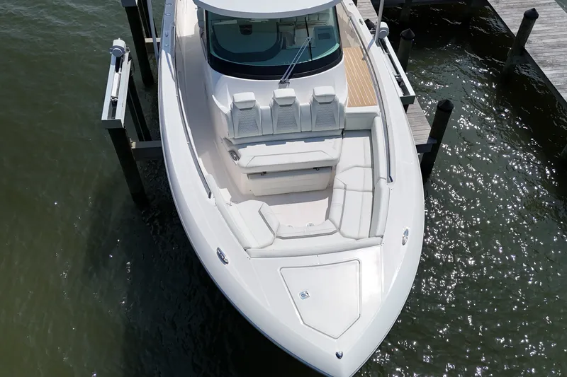 Slide: The Image of 2025 Tiara Yachts 43 LS luxury boat docked, aerial view showcasing sleek design and spacious seating. - 7