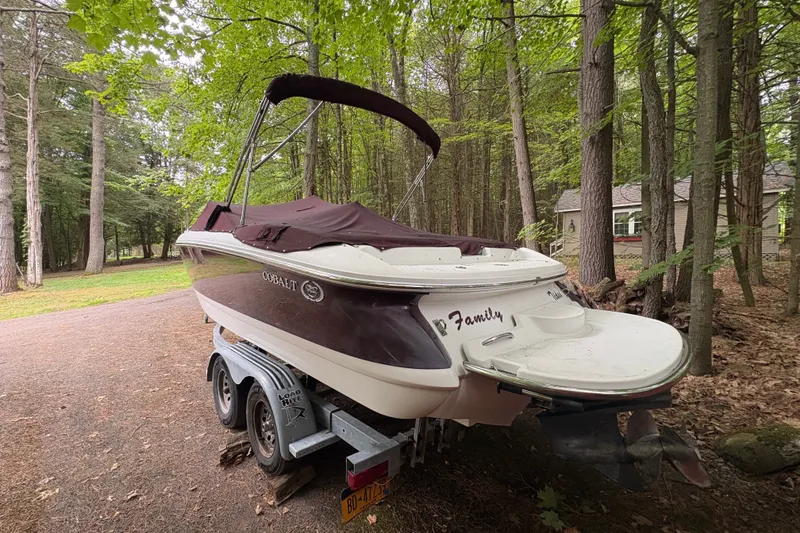 Slide: The Image of 2006 Cobalt 220 boat on trailer in wooded area. - 5