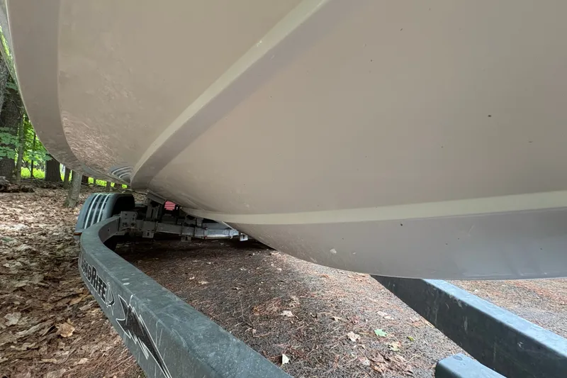 Slide: The Image of 2006 Cobalt 220 boat on trailer in wooded area. - 12